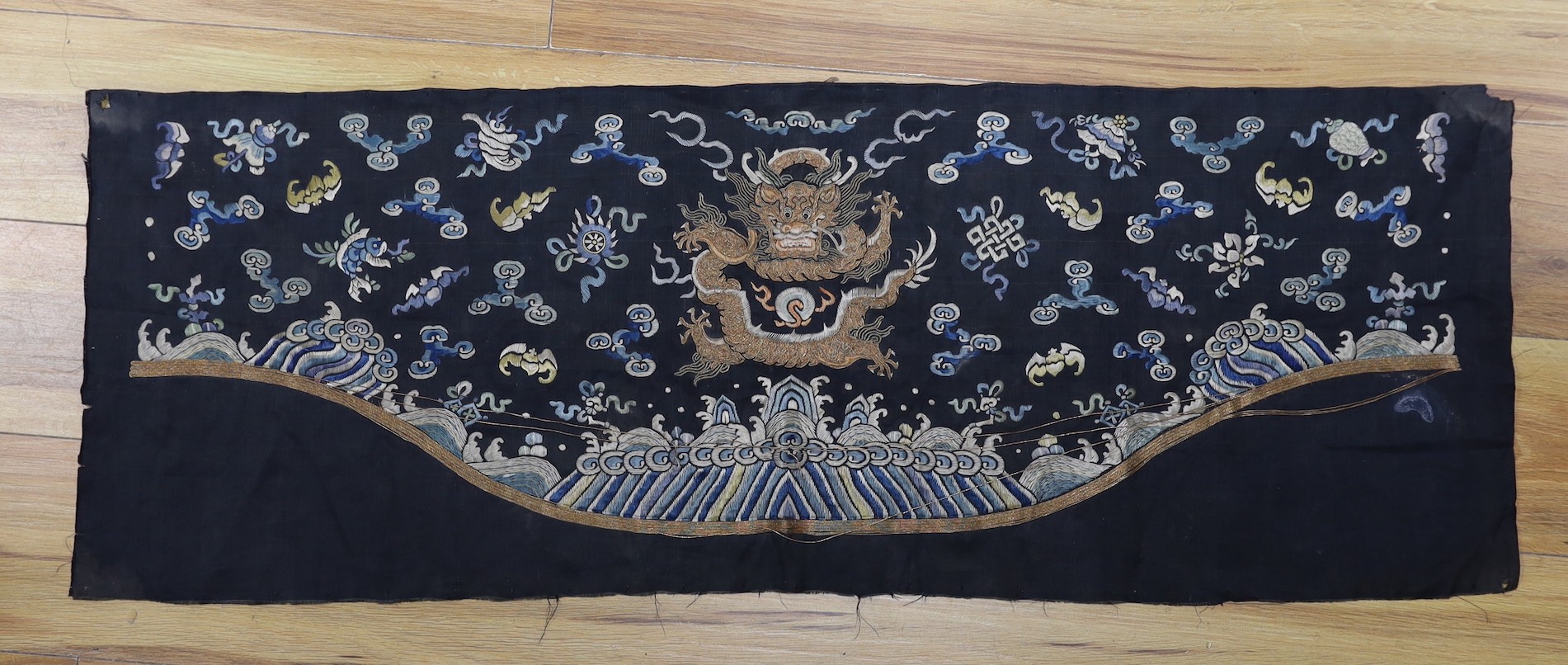 A Chinese late 19th century embroidery of a dragon, probably from a Chinese robe or hanging 37x105cm